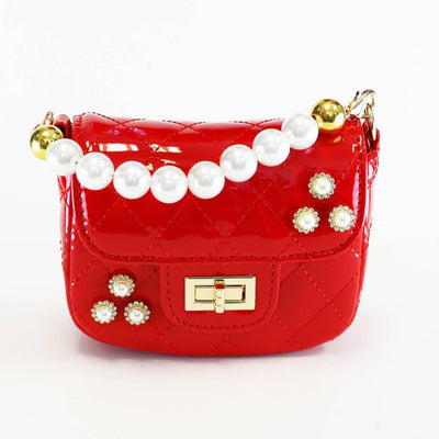 red patent leather purse with pearl handle and turn closure. pearl beads on the flap and body of the purse. 